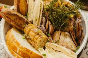 Carboidrato saudável representado por alimentos como aveia, batata-doce, arroz integral, banana, quinoa e feijão sobre uma mesa.